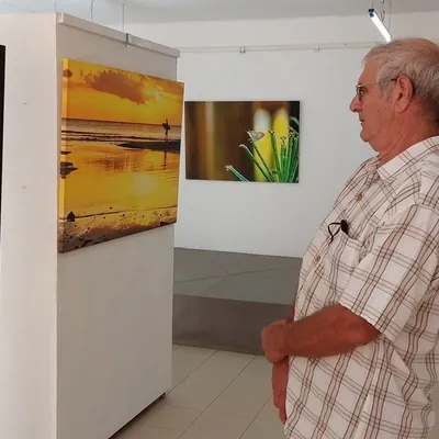 Visitor viewing photo at Photo exhibition at Lakaz Flanbwayan Bambous 