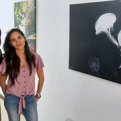 Audrey Cabon posing next to her photo at Bambous Art Gallery 
