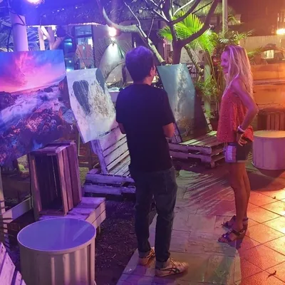 Daniel Cheong explaining his photo to a woman at Photo exhibition