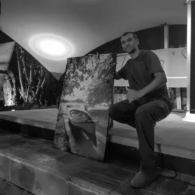 Saleem A Sam posing proudly next to his photo print at Flic en Flac