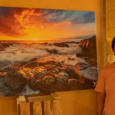 Daniel Cheong and his Sunset photo during photo exhibition at Les Robinsons restaurant