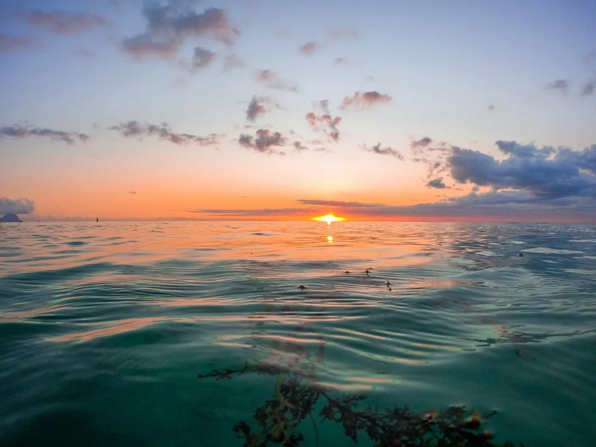 Sunset casting warm light over lagoon at Flic En Flac beach in Mauritius