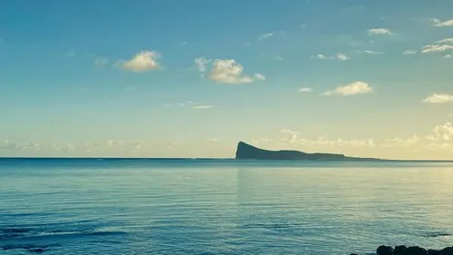 Coin de Mire surrounded by calm ocean at dawn