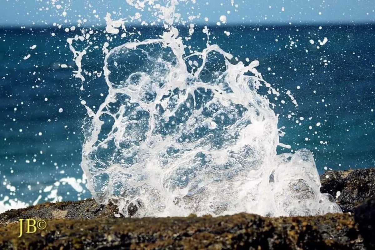 Waves splashing against rocks at La Cambuse shore in Mauritius with natural ocean spray