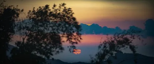 Sunset over mountains & below clouds in Mauritius