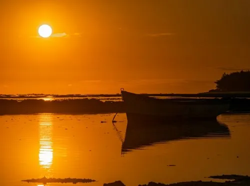 Lonely fishing boat boat silhouette during Sunset at Riambel