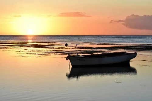 Lonely boat at low tide during sunset in Albion