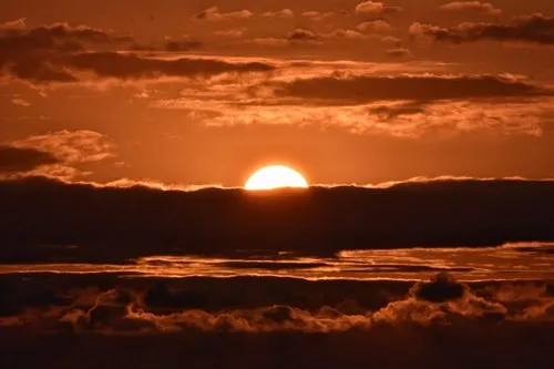 Sunset closeup behind clouds in Albion