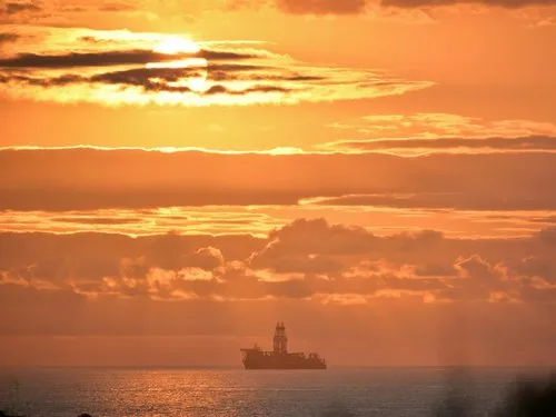 Supply vessel leaving Port Louis during sunset