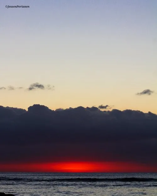 Reddish sunset under clouds at Pointe aux Piments