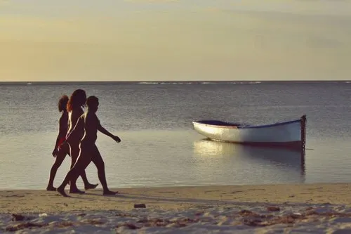 Mauritian women walking on the beach of Albion