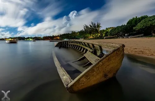 Stranded wooden fishing boat at Bain Boeuf beach