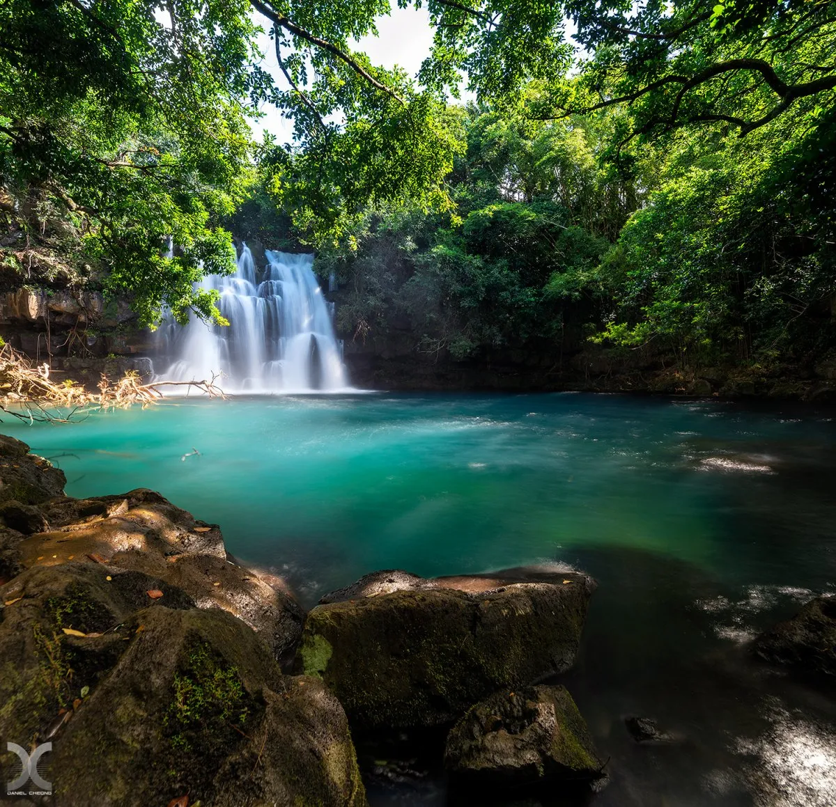 Eau Bleue secret waterfall surrounded by lush forest and rocks in Mauritius