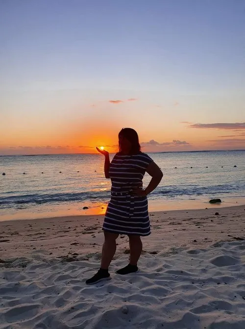 Mauritian woman holding the sun in her hand