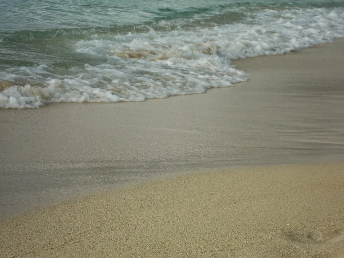 Sea waves crashing on the beach in front of Royal Palm Beachcomber hotel in Grand Bay Mauritius