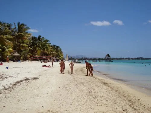People in swimwear on the beach at Trou Aux Biches