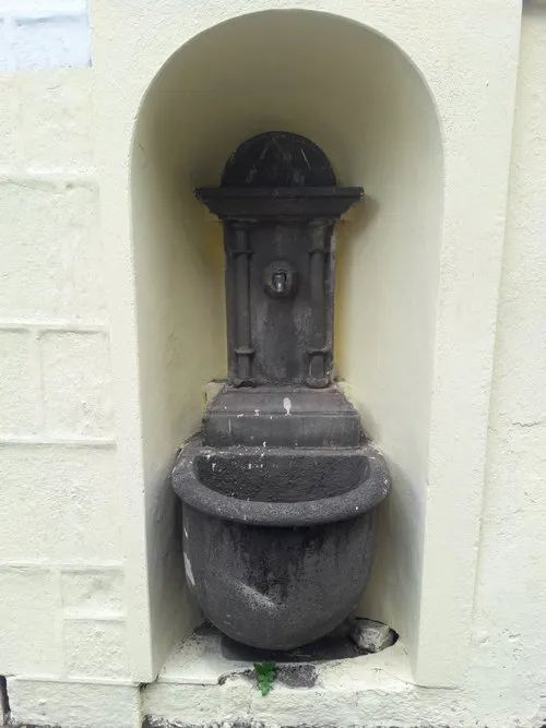 Old stone fountain in Port Louis near Champs de Mars