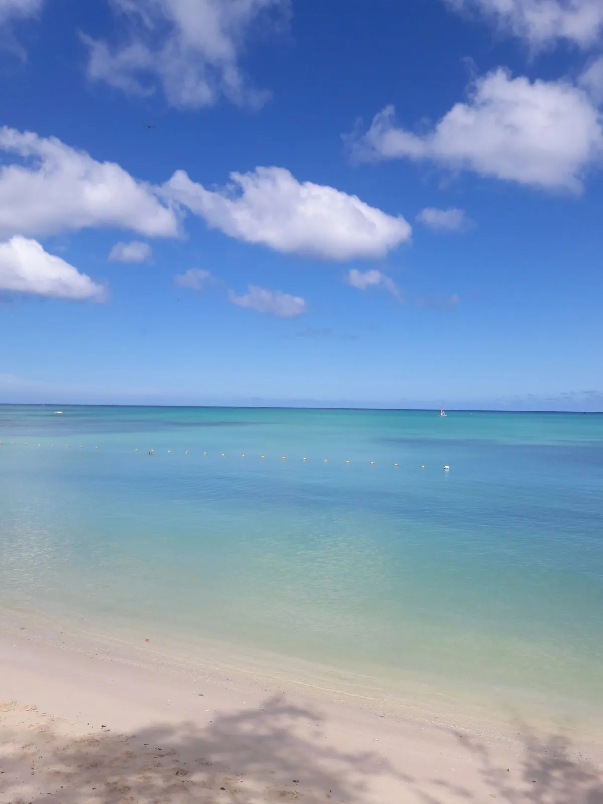 Calm sea and white sandy beach at Mont Choisy in northern Mauritius on a beautiful day