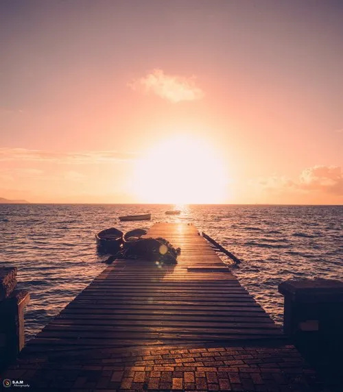 Mahebourg jetty leading to the early morning lights of the sun