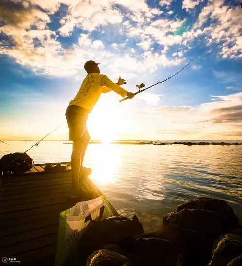 Fisherman throwing his rod in the lagoon in Flic en Flac