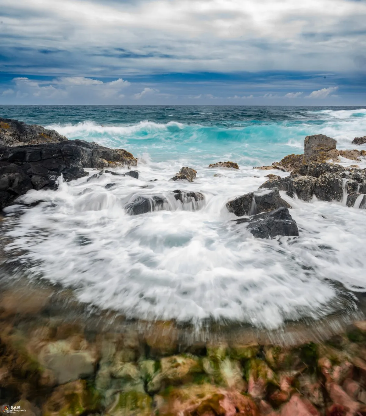 Long exposure photo of sea foam on the rocky beach at La Cambuse, Mauritius