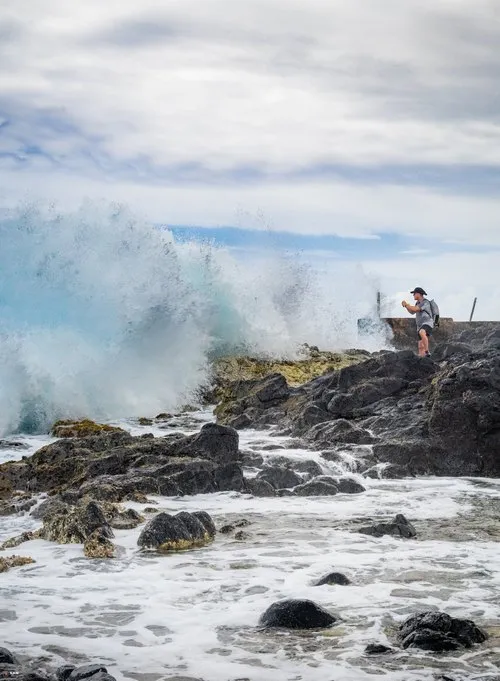 Big splash by large dangerous waves near tourist at La Cambuse