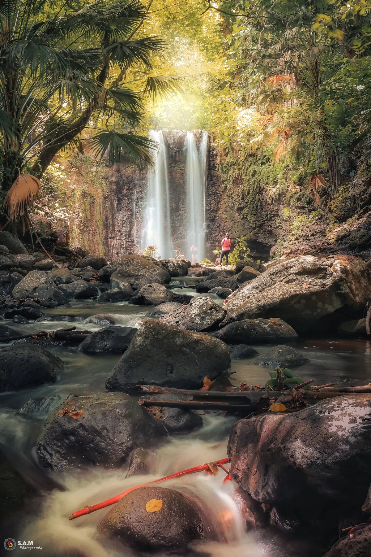 Long exposure photo of Cascade Mamzelle waterfall near Gris Gris beach surrounded by lush forest in Mauritius