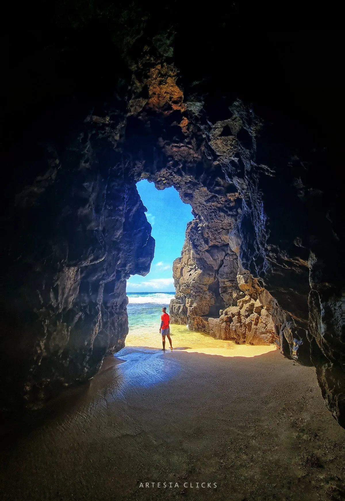 View from inside a natural beach cave looking out to the sea at Gris Gris beach in Mauritius