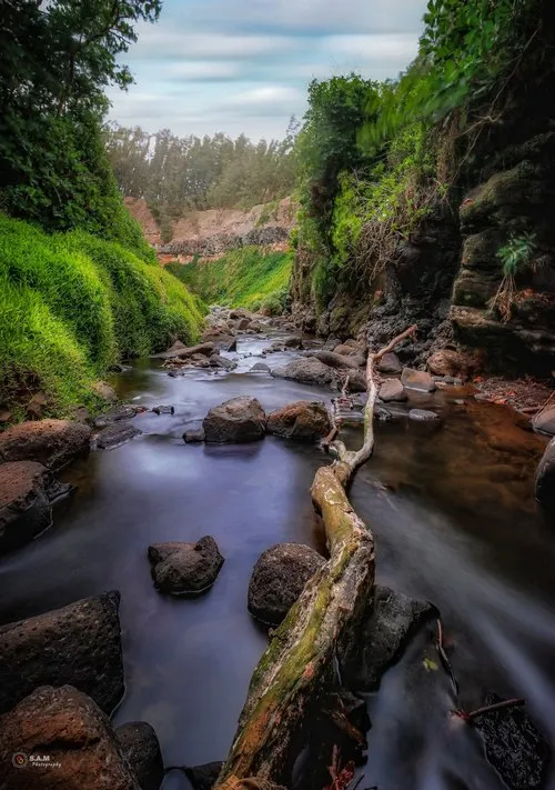 Long exposure of cliff river flowing in nature in Mauritius