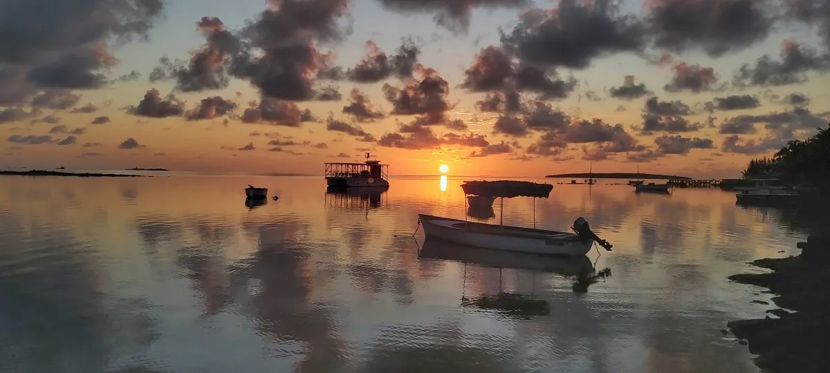 Sunrise over calm sea at Mahebourg Waterfront in Mauritius with clear sky and gentle light