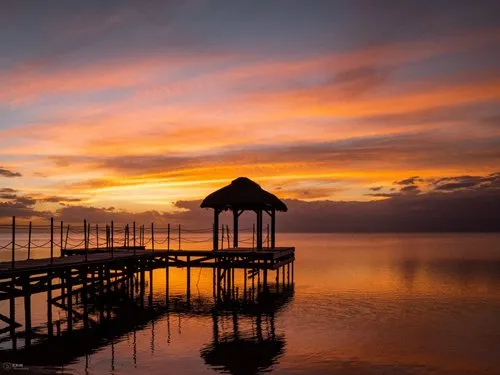 Jetty with orange clouds during Sunset at Flic en Flac beach