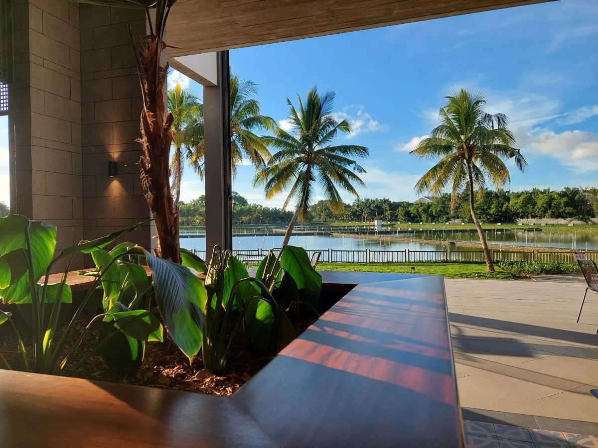 Peaceful lake view at Mahogany Mall promenade with trees and architecture in Mauritius
