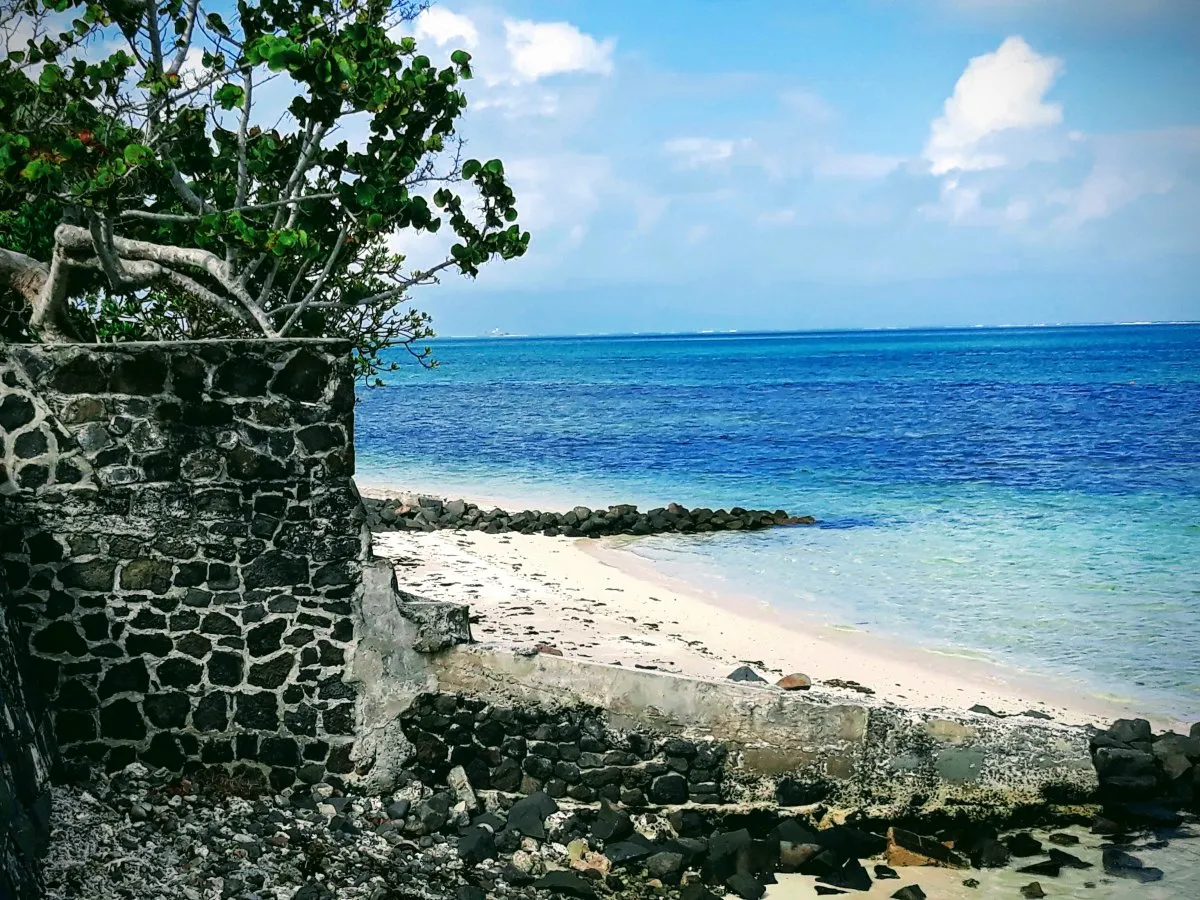 Collapsed wall at pristine Pointe d'Esny beach in Mahebourg, Mauritius