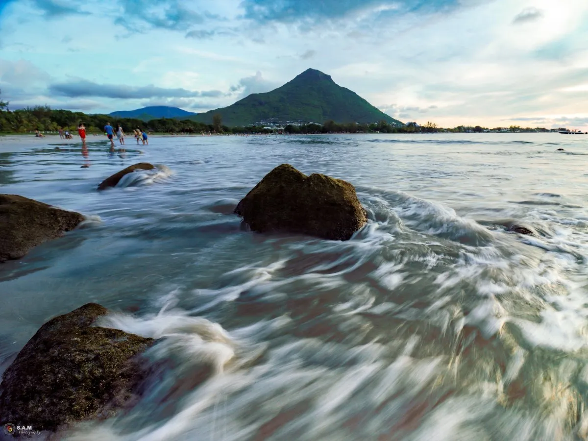 Long exposure photo of Tamarin Beach with mountains in the afternoon in Mauritius