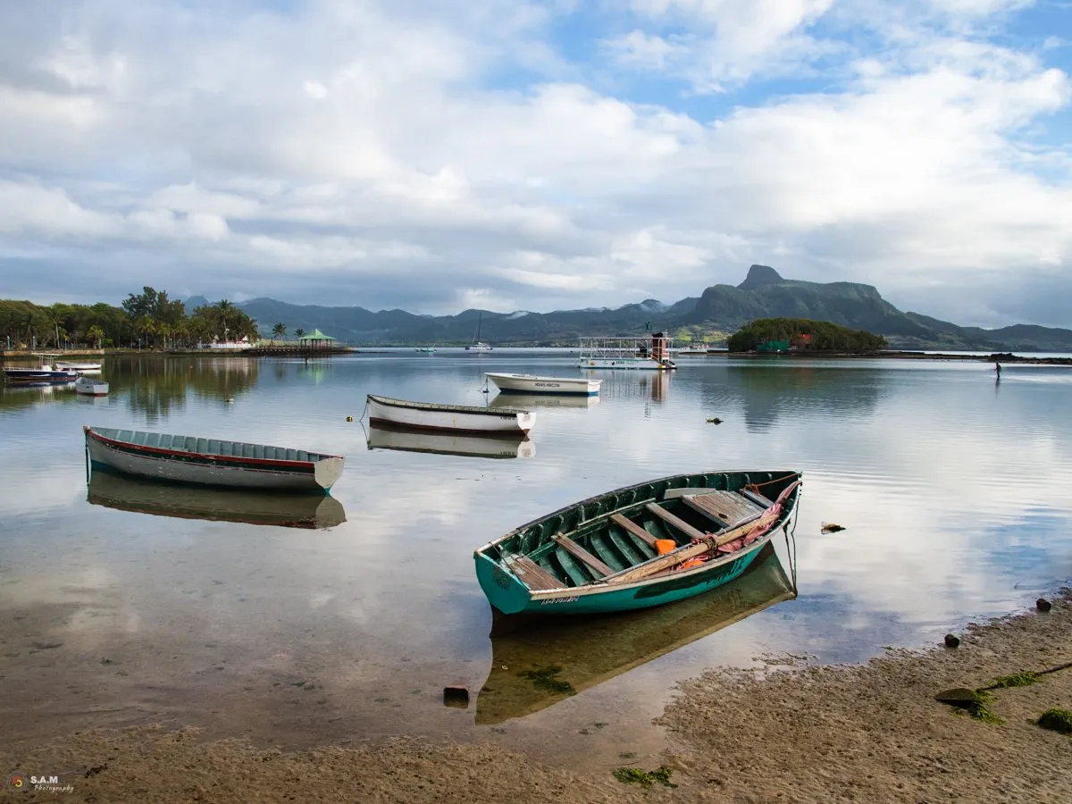 Fishing pirogues resting in the low tide lagoon at Mahebourg, Mauritius