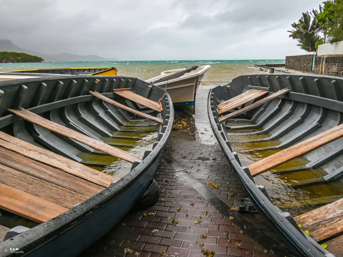 Fishing boats filled with rain on shore during cyclone in Mahebourg, Mauritius
