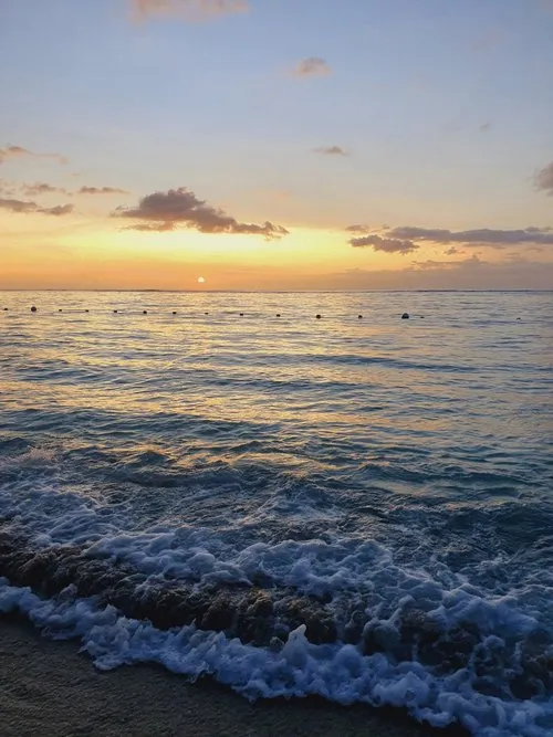 Waves reaching the shores during sunset at Flic en Flac