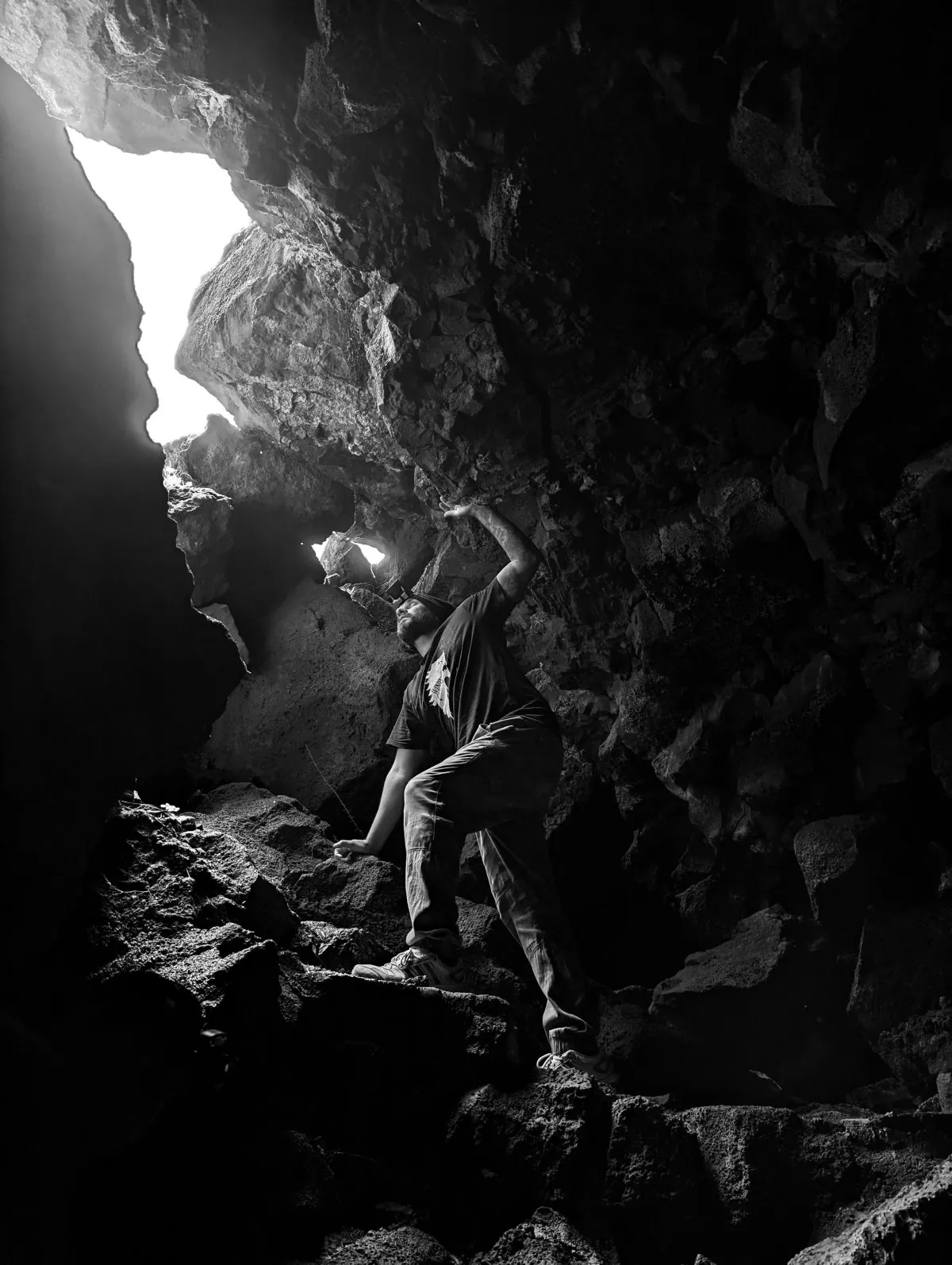 Man climbing out of a large cave in Flacq, Mauritius, captured by local photographer Fardeen