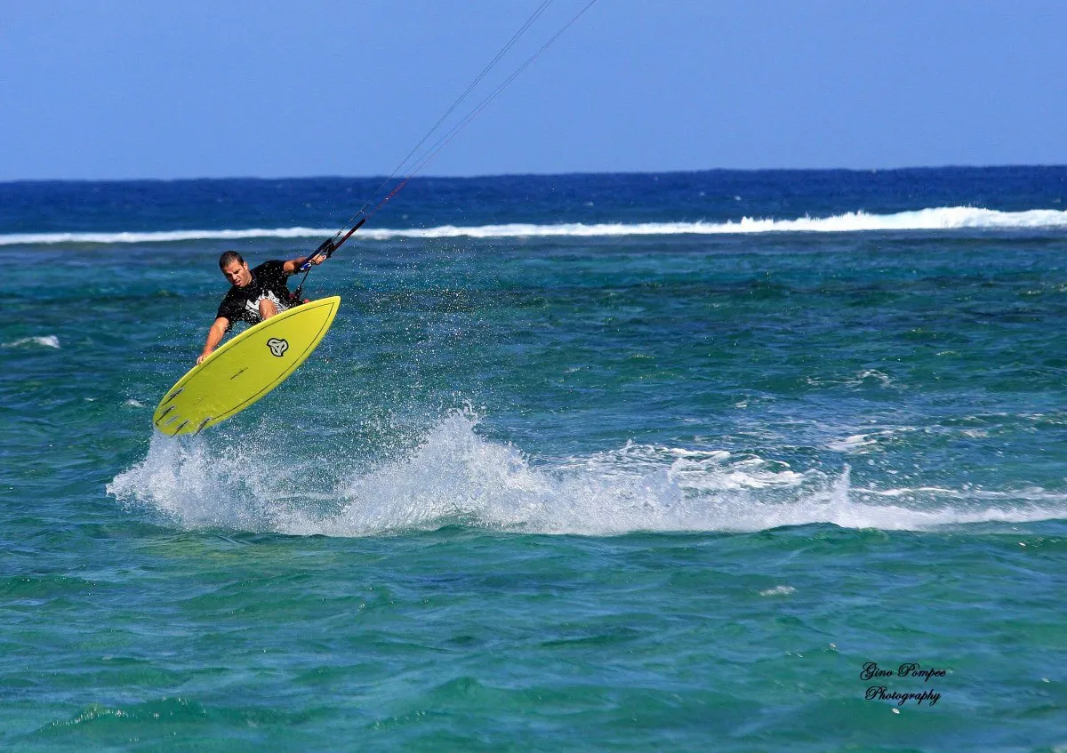 Kite-surfing over the blue lagoon at La Prairie, Mauritius under clear skies