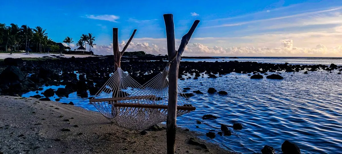 Rope hammock on Shanti beach with sunset sea view in Mauritius