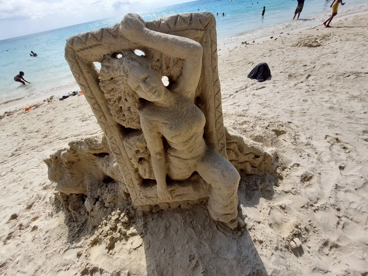 Sand sculpture of a lady framed on Pereybere Beach in Mauritius by a local artist.