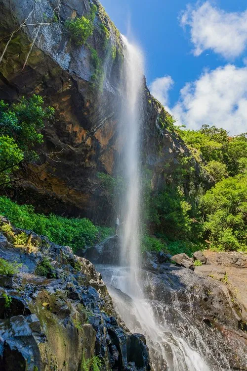 Short exposure with man posing behind waterfall at Tamarind Falls