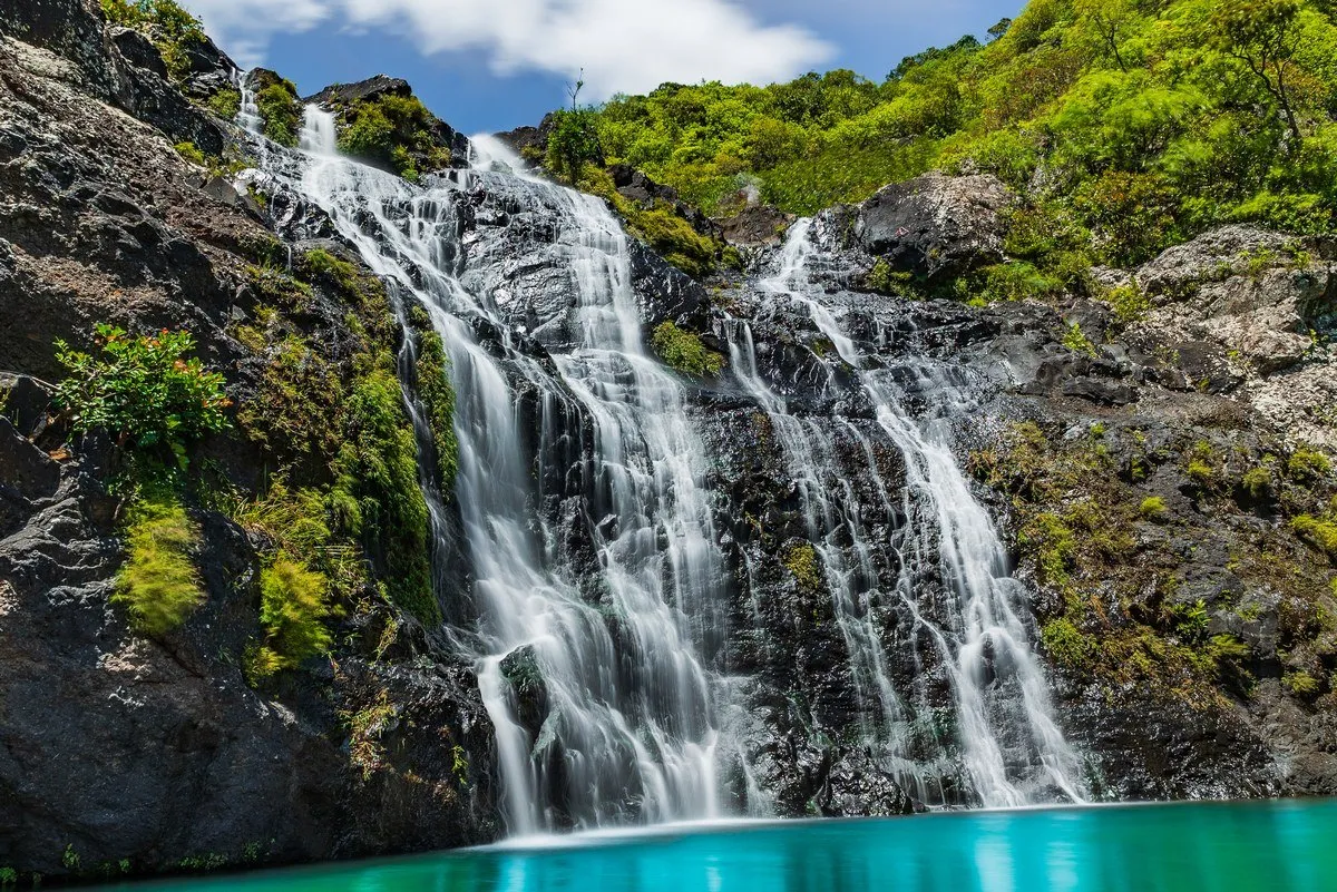 Long exposure photo of water gently slipping over rocks at 7 Cascades in Mauritius