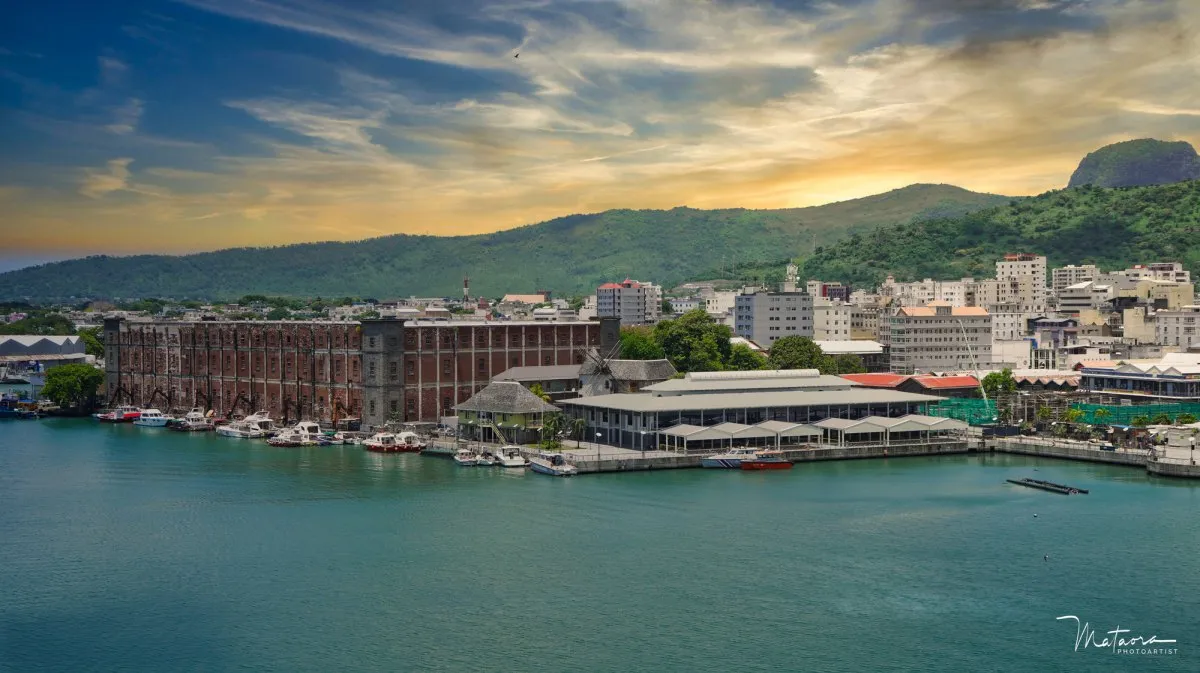 Aerial sunset view of Astrolab Waterfront and harbor in Port Louis, Mauritius, with dramatic sky and cityscape