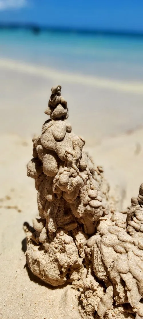 Sculpture of dripping off sand on the beach