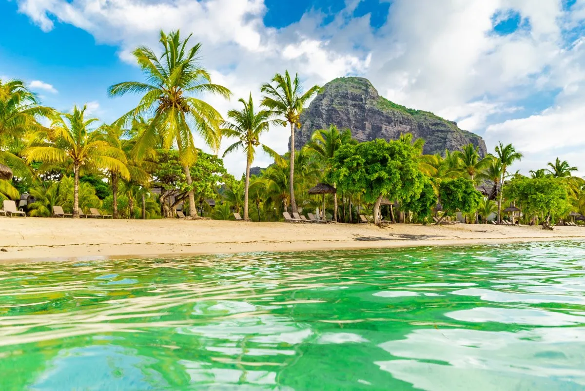 Lagoon and beach at Le Morne with Brabant Mountain in Mauritius under clear sky