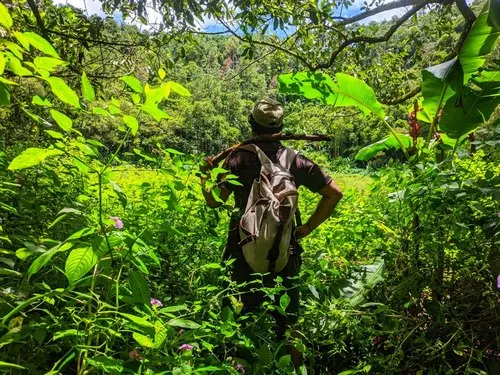 Man standing inside Trou aux Cerfs crater