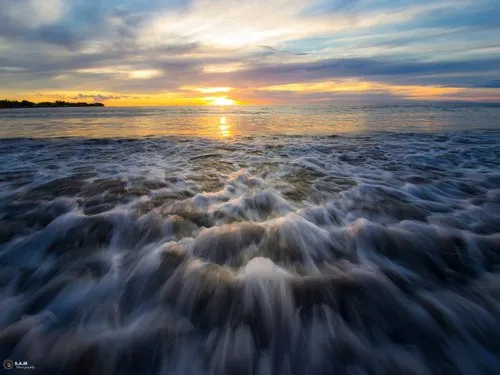 Closeup of sea foam reaching the shore at Tamarin beach