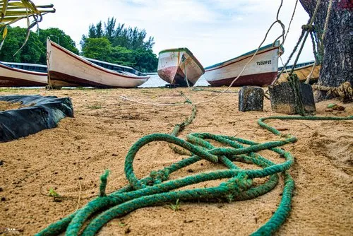 Fishing pirogue tied on the beach at Bel Ombre
