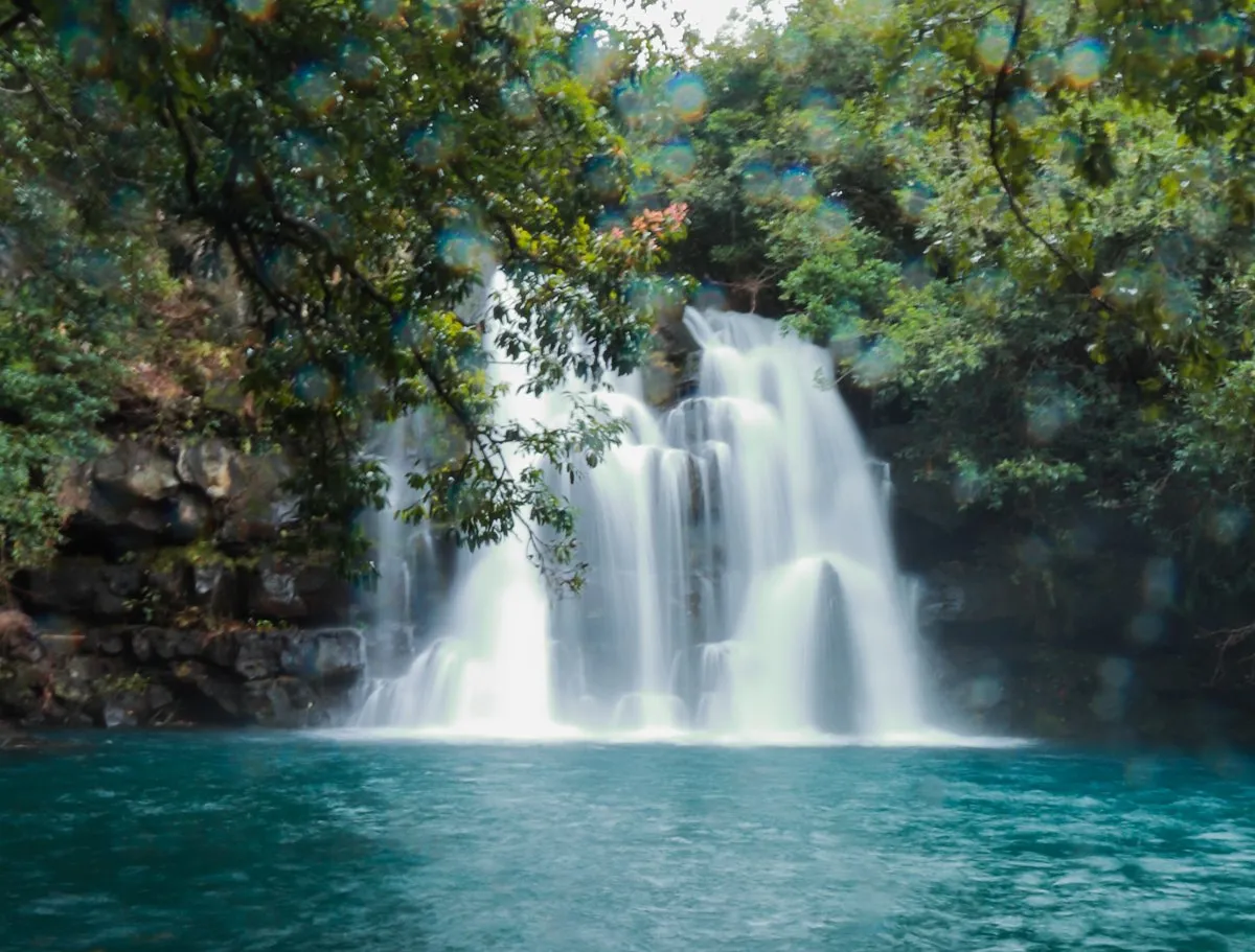 Long exposure photo of Eau Bleu waterfall surrounded by lush greenery in Mauritius